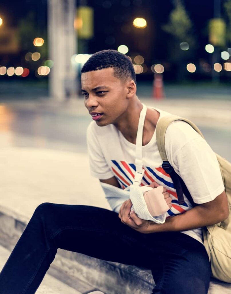 Injured young man with arm support