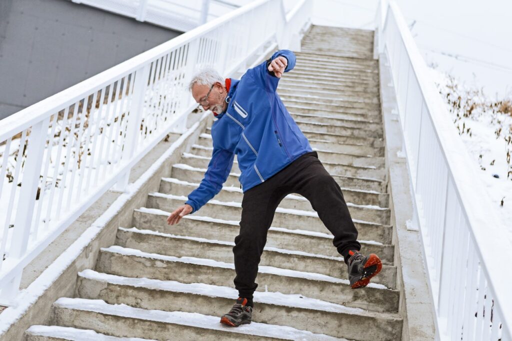 Senior man on a icy staircase falling